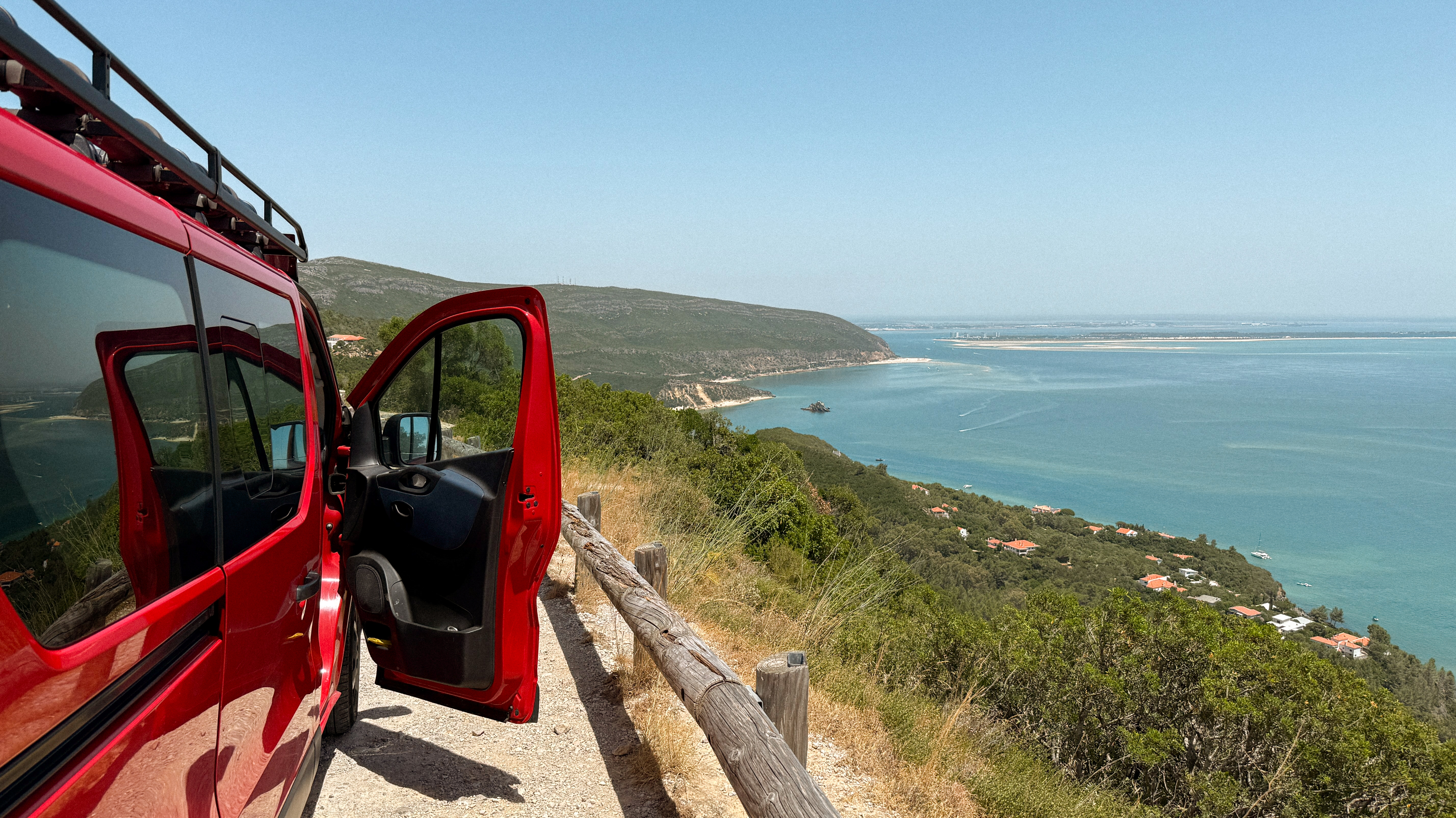 Red campervan parked overlooking the Portuguese coast